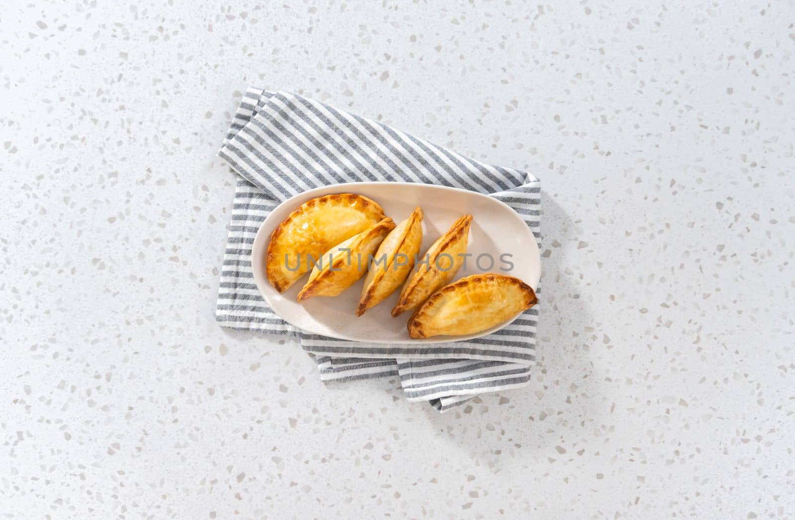 Flat lay. Freshly baked breakfast empanadas with eggs and sweet potato on the kitchen counter.