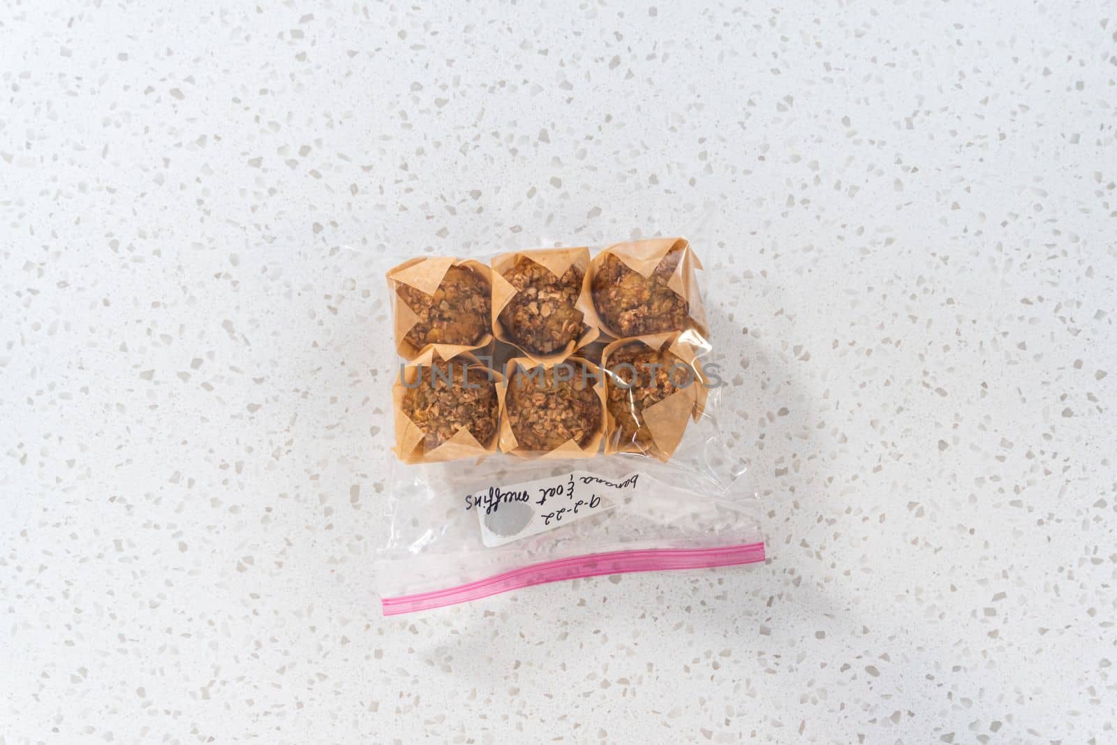 Flat lay. Meal prepping. Packaging banana oatmeal muffins into the plastic back to store in a freezer.