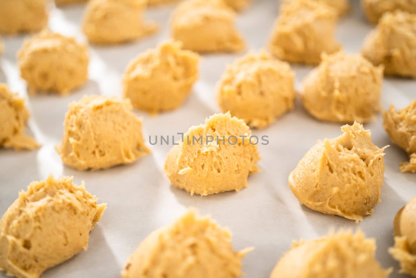 Scooping dough with dough scoop to bake eggnog scones.