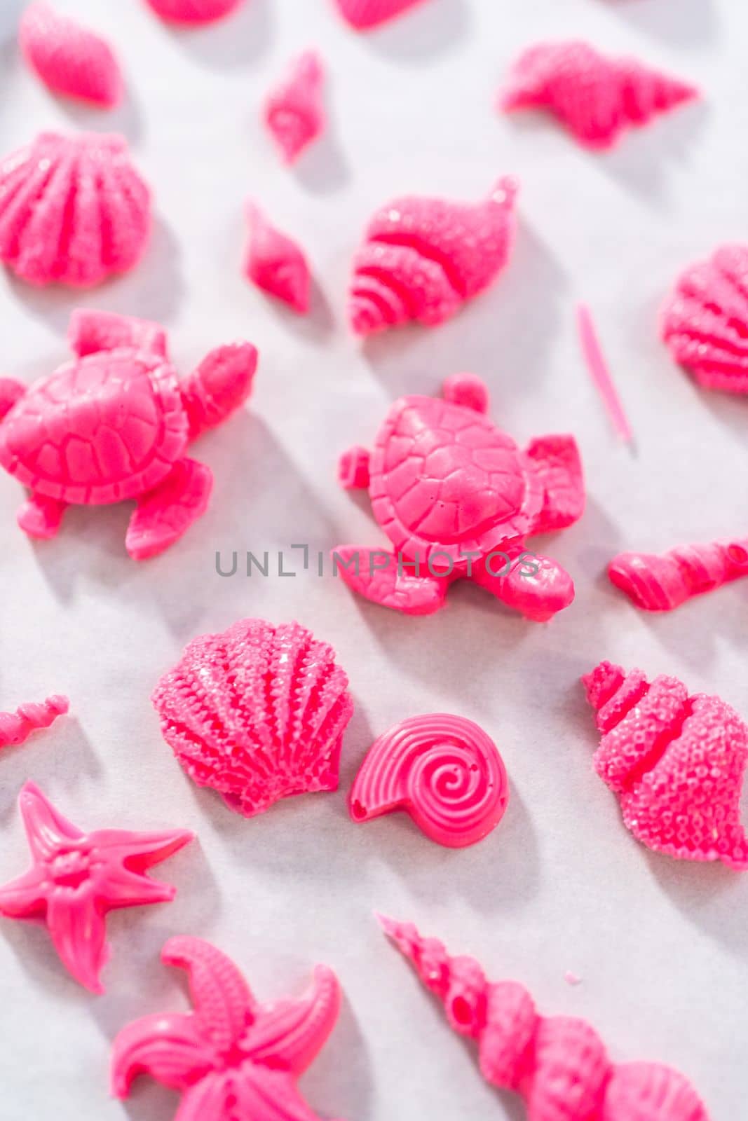 Making sea-shaped chocolates to decorate chocolate-dipped pretzels twists.