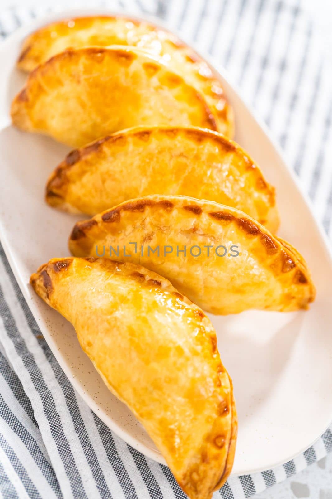 Freshly baked breakfast empanadas with eggs and sweet potato on the kitchen counter.