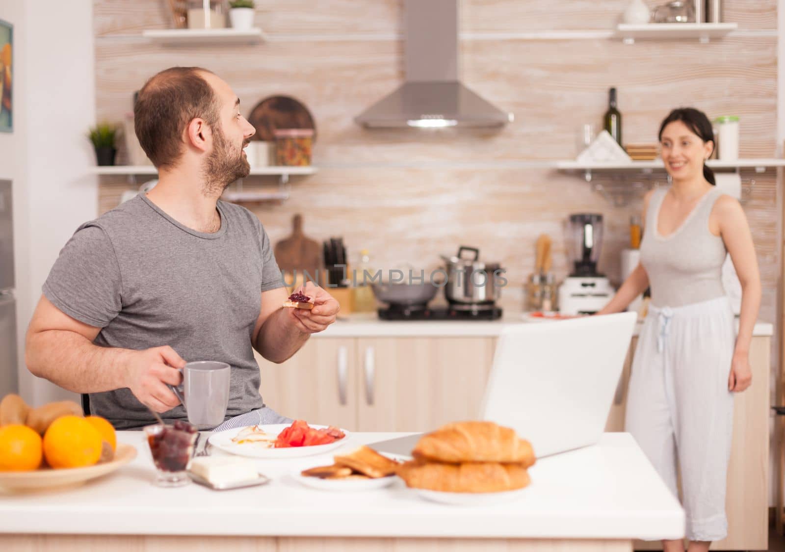 Excited freelancer working from home on laptop after reading a good news. Successful overjoyed euphoric entrepreneur at home in the morning, winner and business triumph