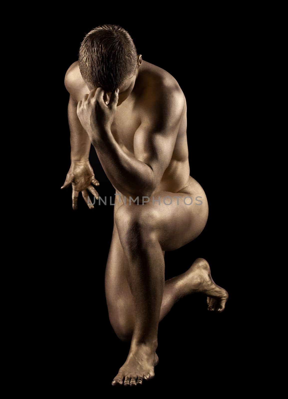 Naked strong man posing in gold skin by rivertime