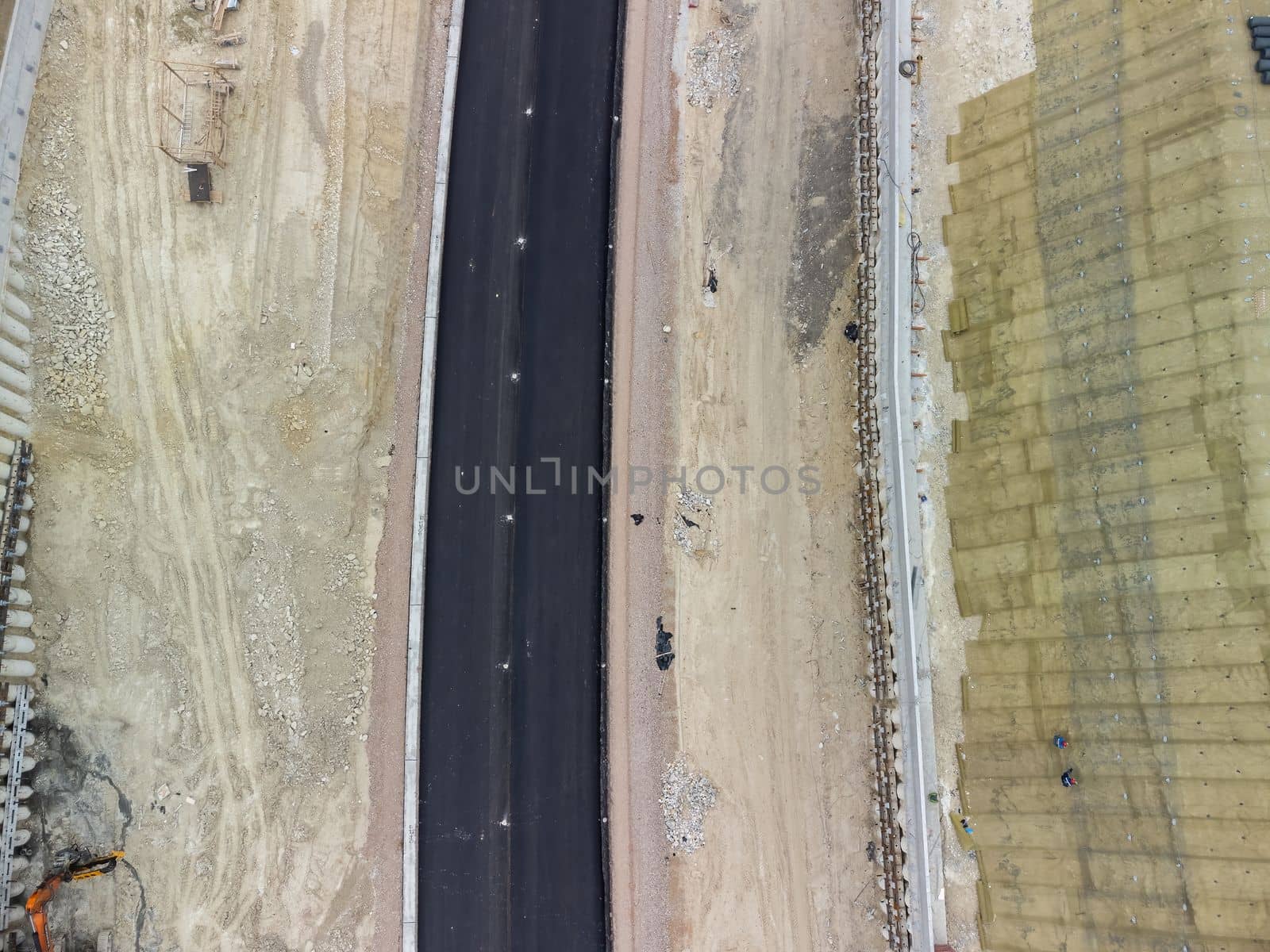 Aerial drone shot Road construction in progress in wild nature canyon.
