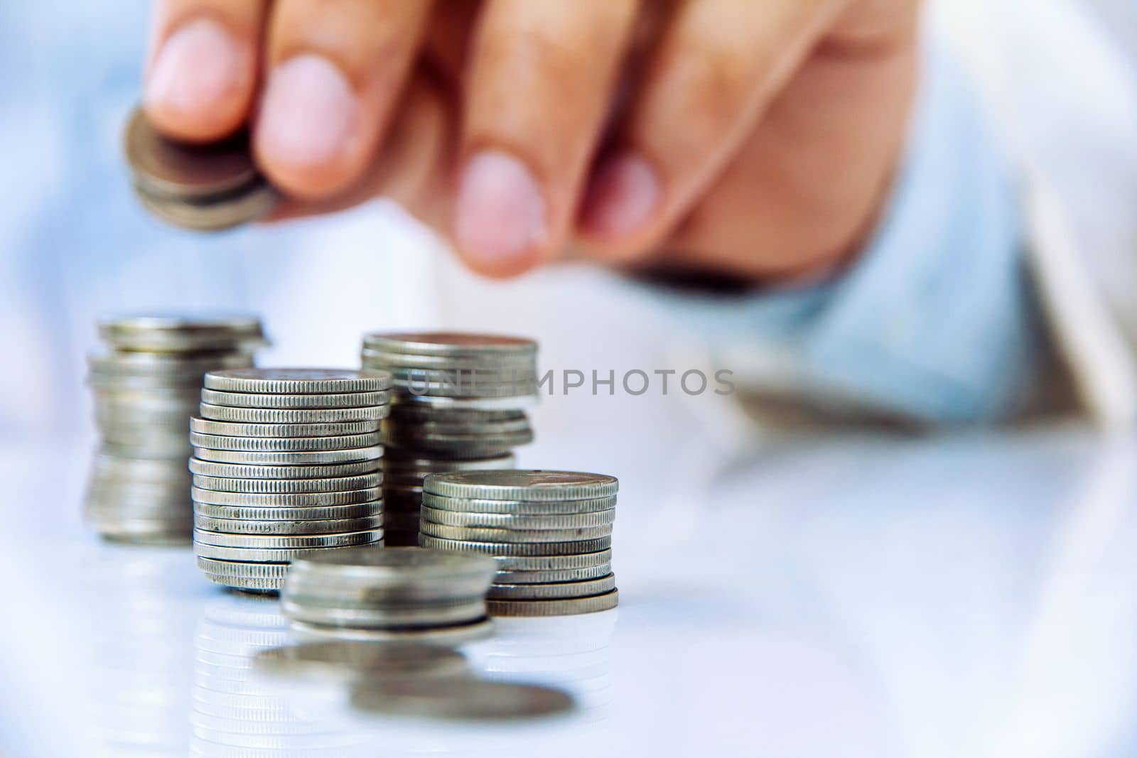 Hand put coin to stack, investment concept