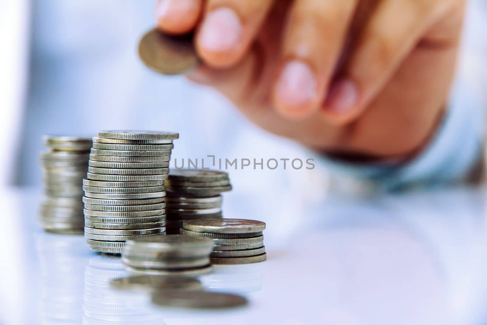 Hand put coin to stack, investment concept by ponsulak