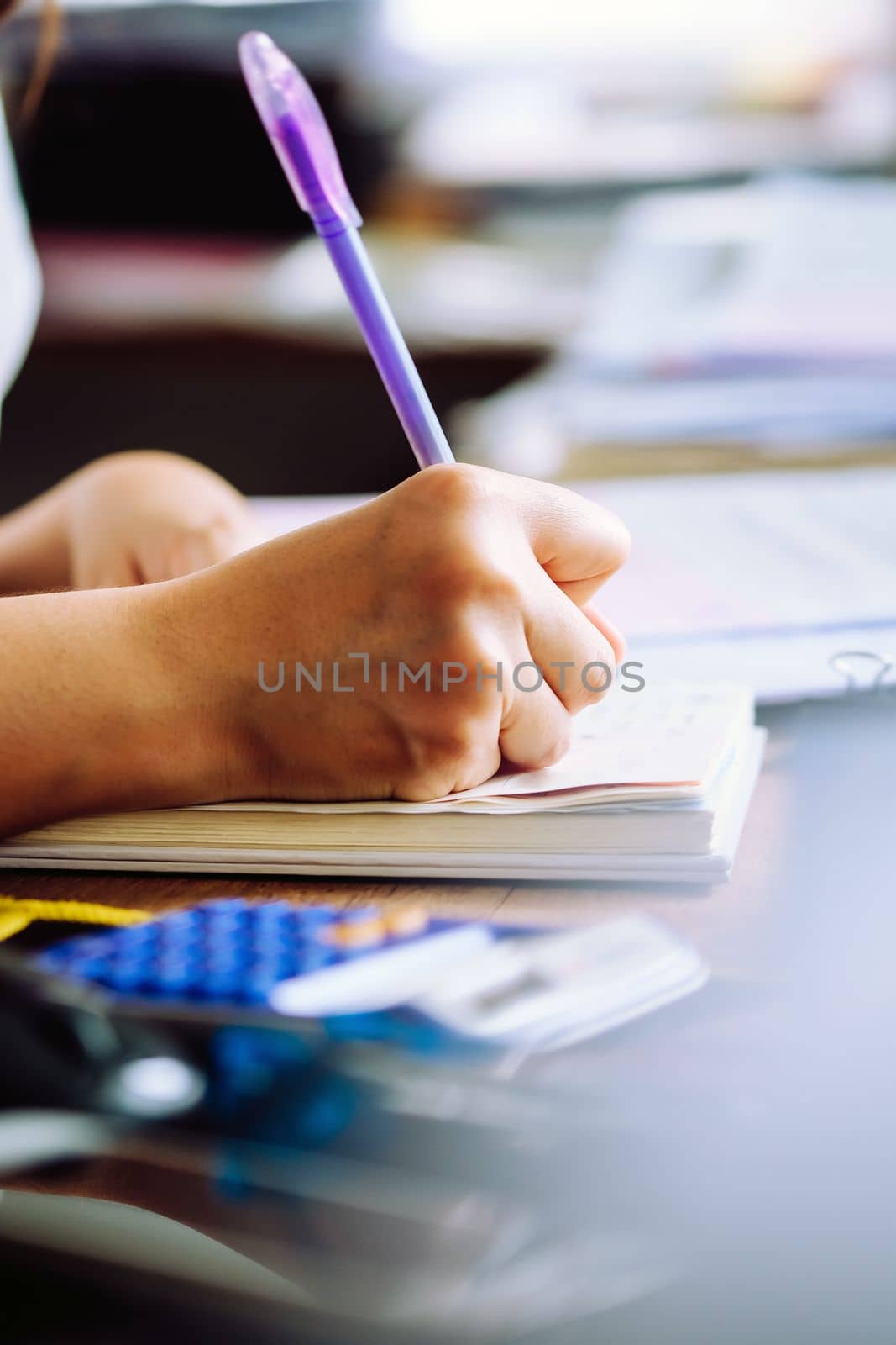 Close up female hands of accountant with calculator and pen. business accounting background.