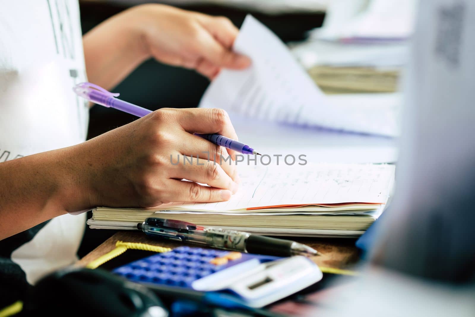 Close up female hands of accountant with calculator and pen. business accounting background.