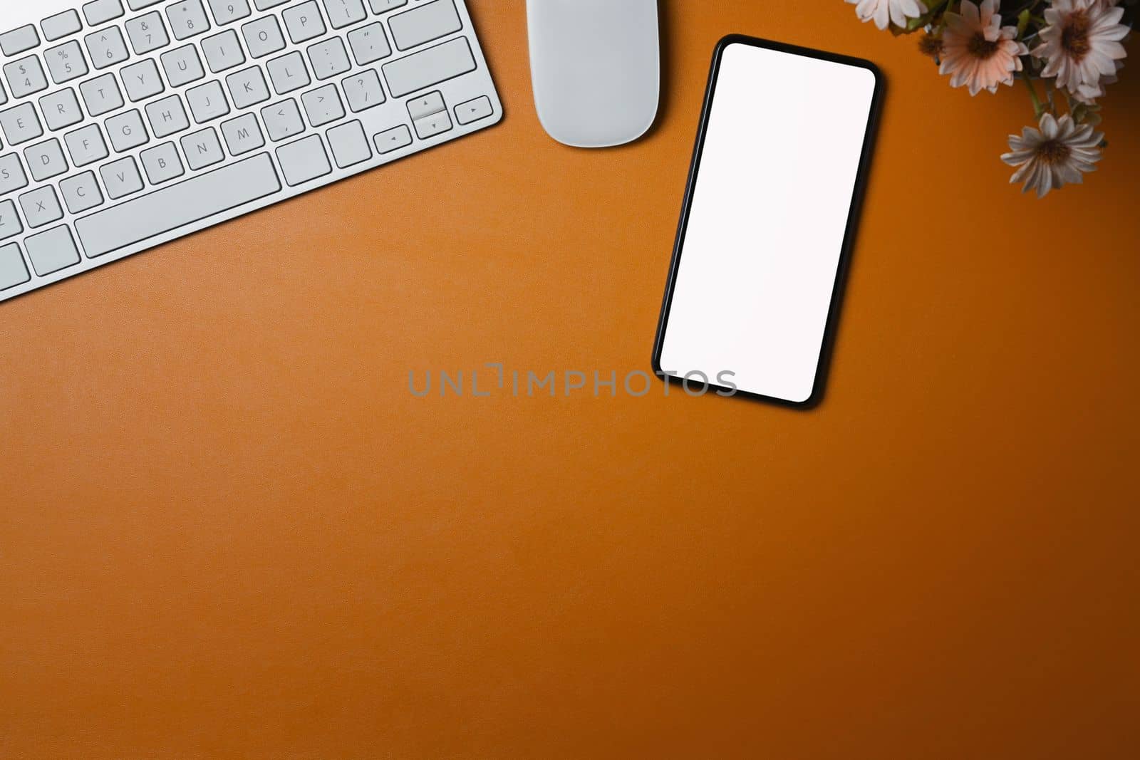 Mock up smart phone with blank display on orange leather. by prathanchorruangsak