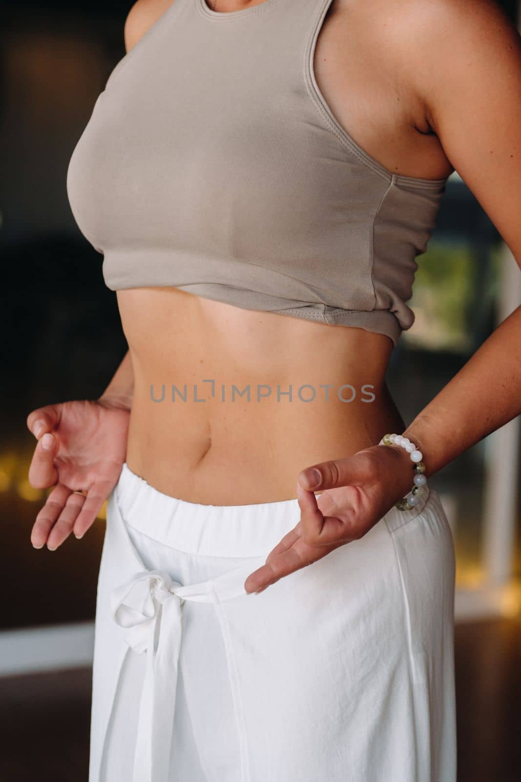 a woman does breathing exercises in the fitness room. Home sports training for the muscles of the press.