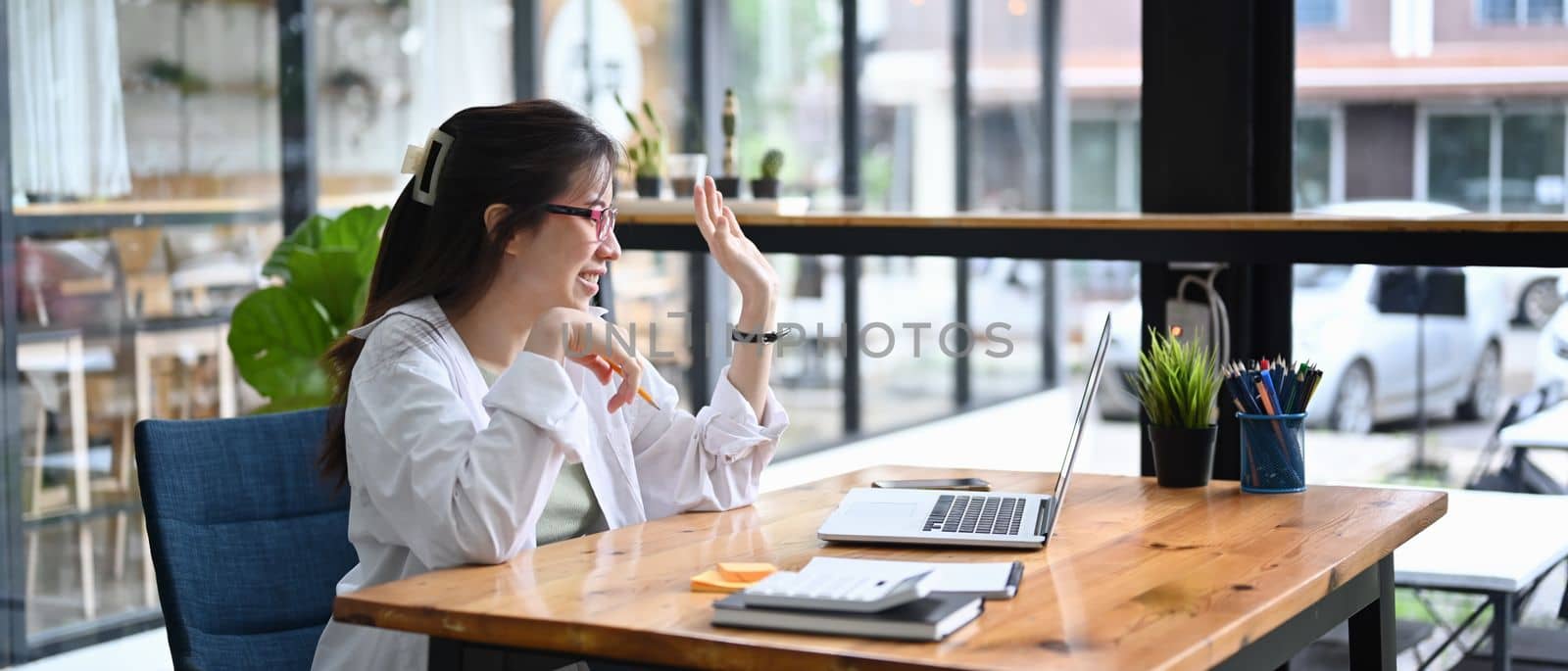 Smiling woman having video call on laptop computer.
