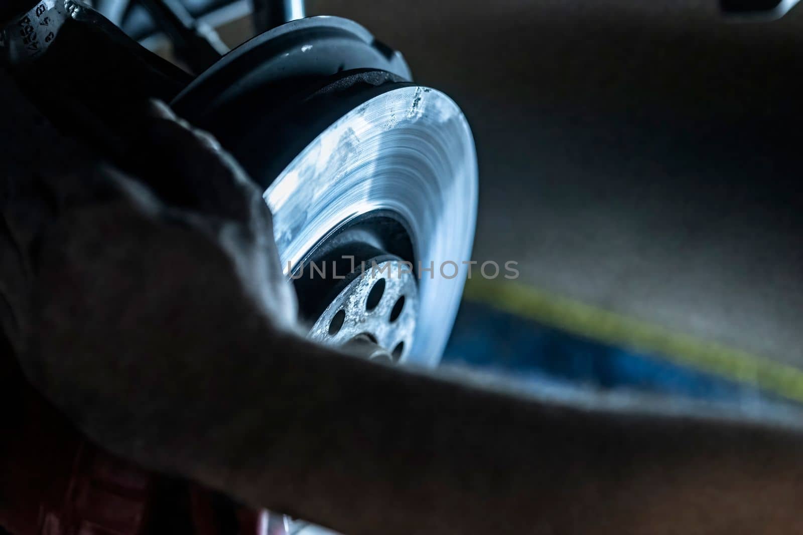 Mechanic hands detail during a maintenance of car brakes