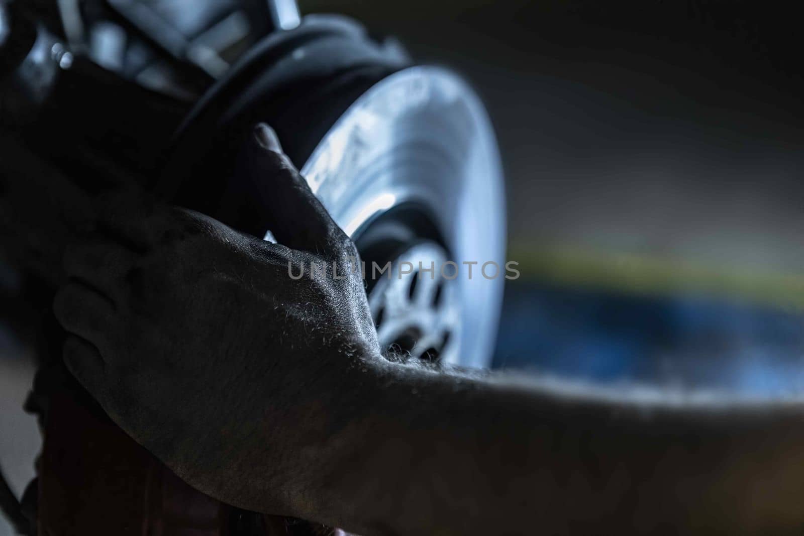 Mechanic hands detail during a maintenance of car brakes