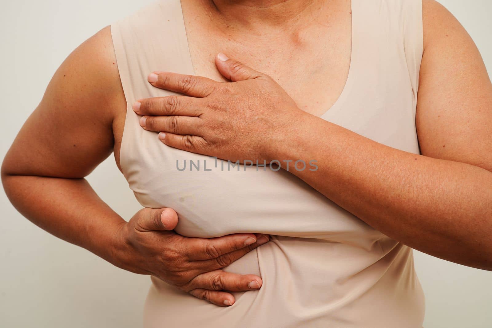 Asian woman self touching check lump or Breast cancer, Breast Self Exam. 