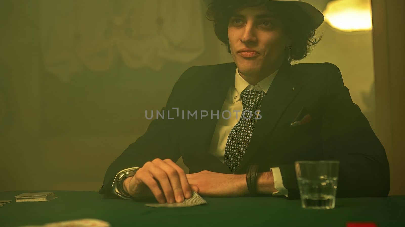 Poker players disappointed look as he drops the cards on the table during a game by pippocarlot