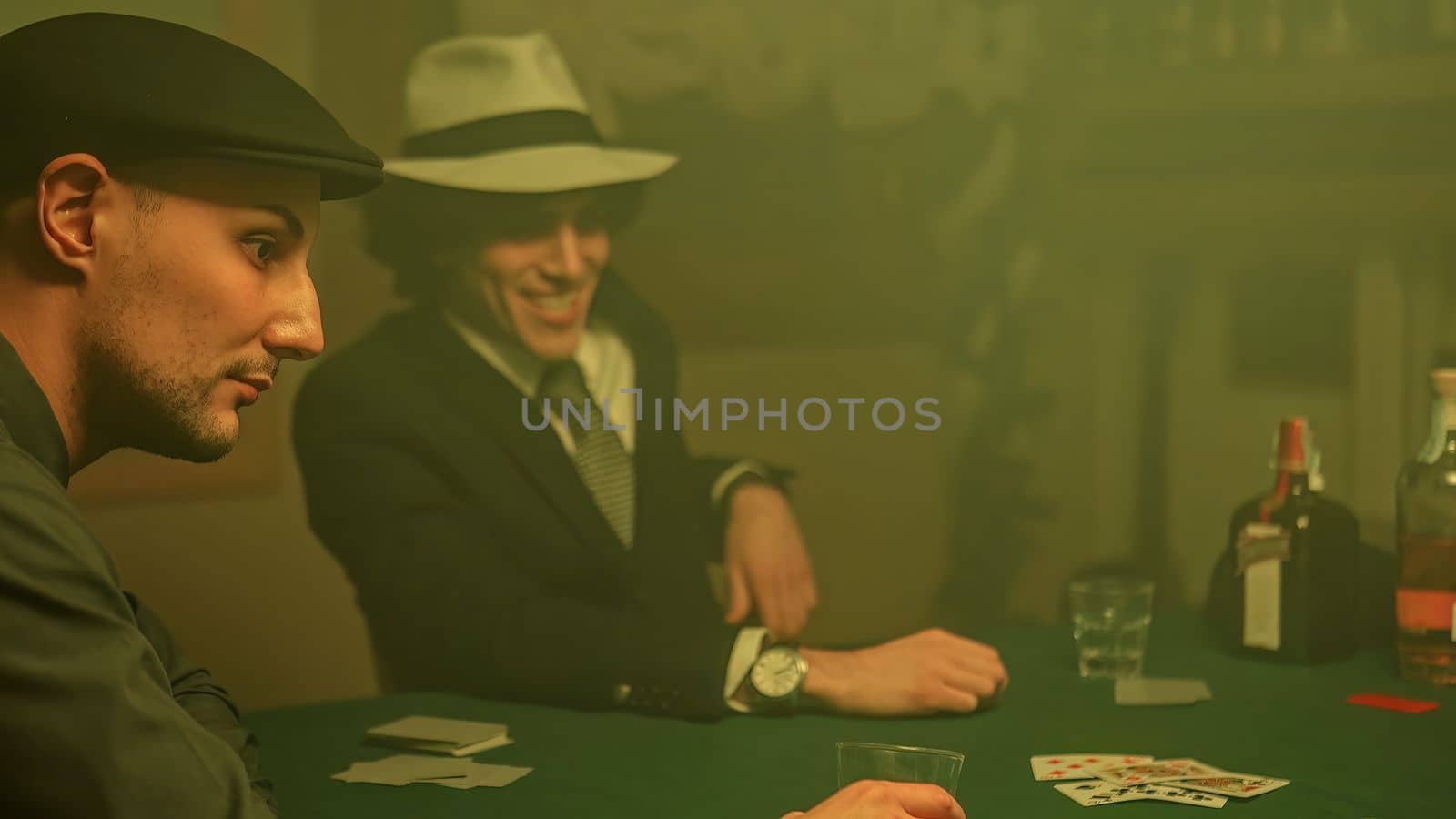 A defeated poker player stares down at his cards and drops them on the table by pippocarlot
