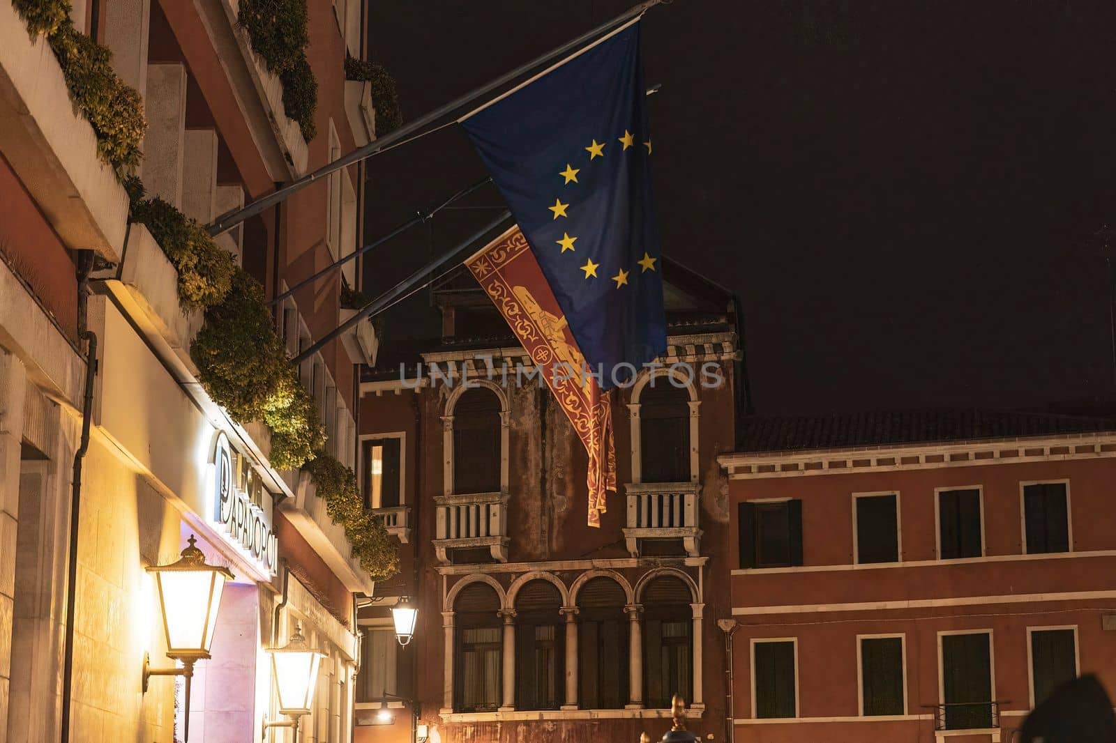 European flag on italian building at night