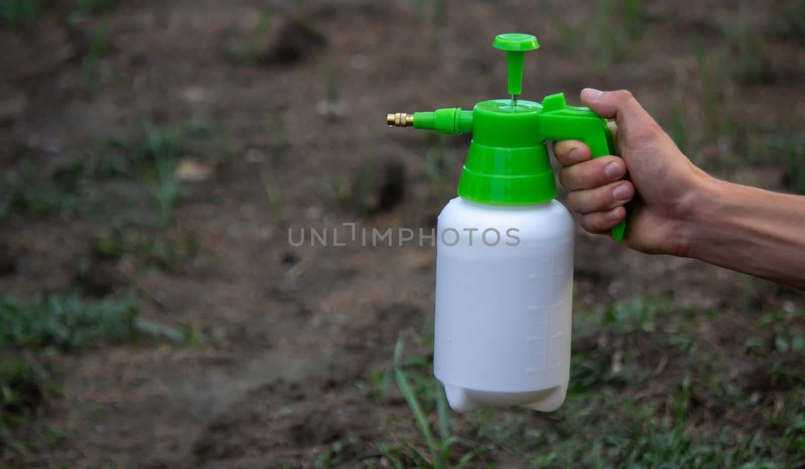 farmer sprays weeds in the garden. Selective focus. nature