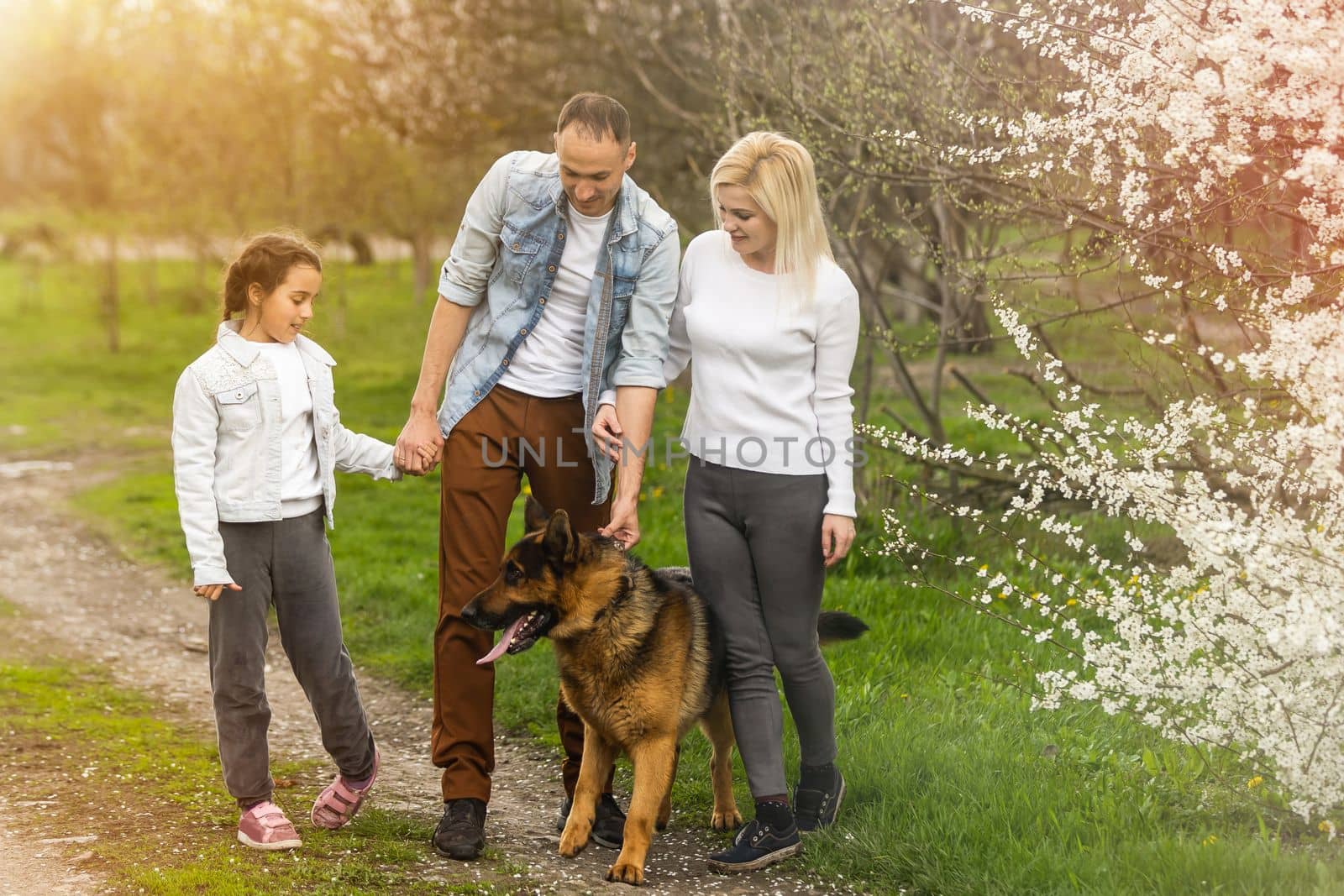 Young family with children and with dog having fun in nature.