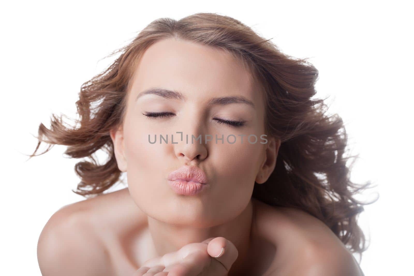 Sexy woman air kissing with close eyes. Isolated on white