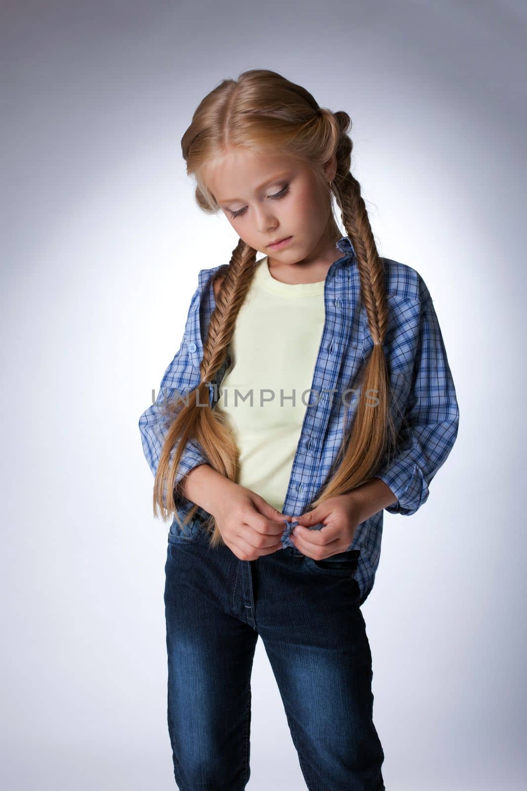 Studio portrait of pretty blonde Thoughtful girl