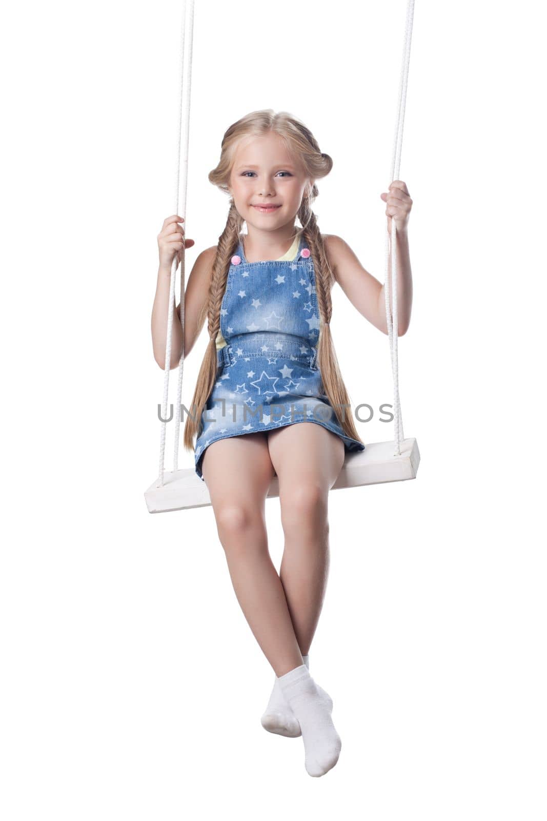 Studio portrait of beautiful blonde girl sit on swing. Isolated on white
