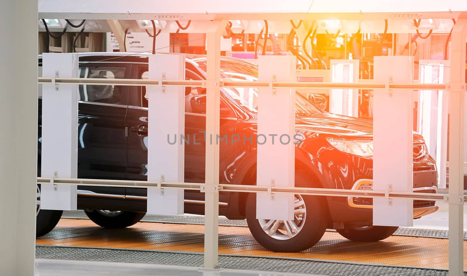 Photo of automobile production line. Modern car assembly plant. Modern and high-tech automotive industry. Conveyor of auto bodies