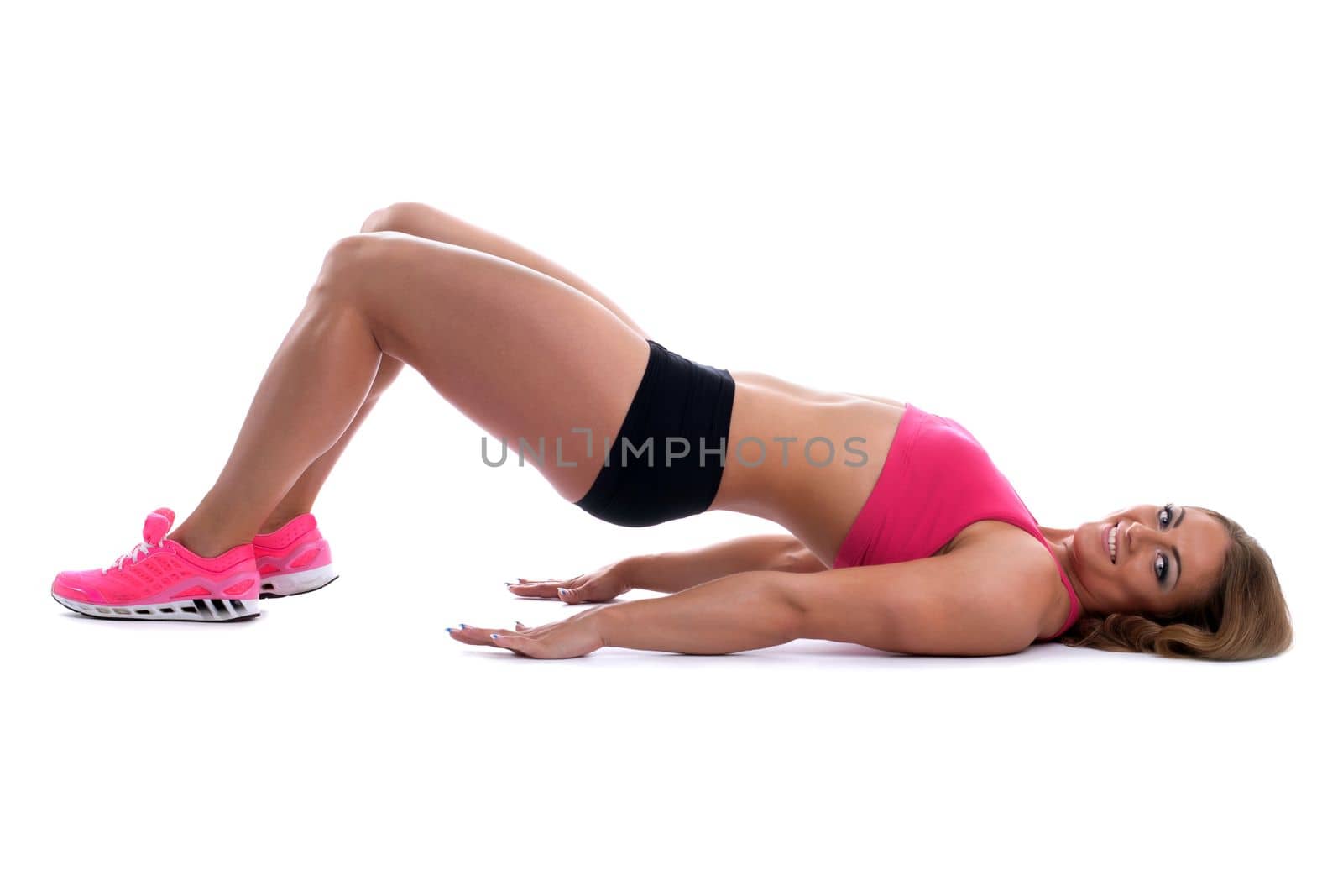 Beauty strong woman with muscle body lay on isolated background