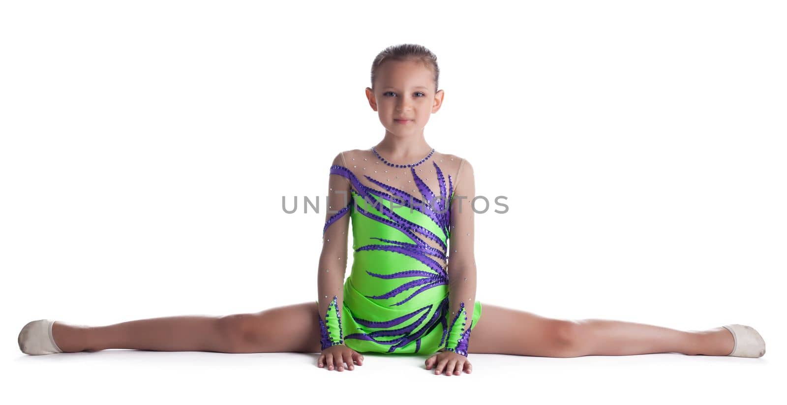 Kid gymnast doing split in green costume isolated