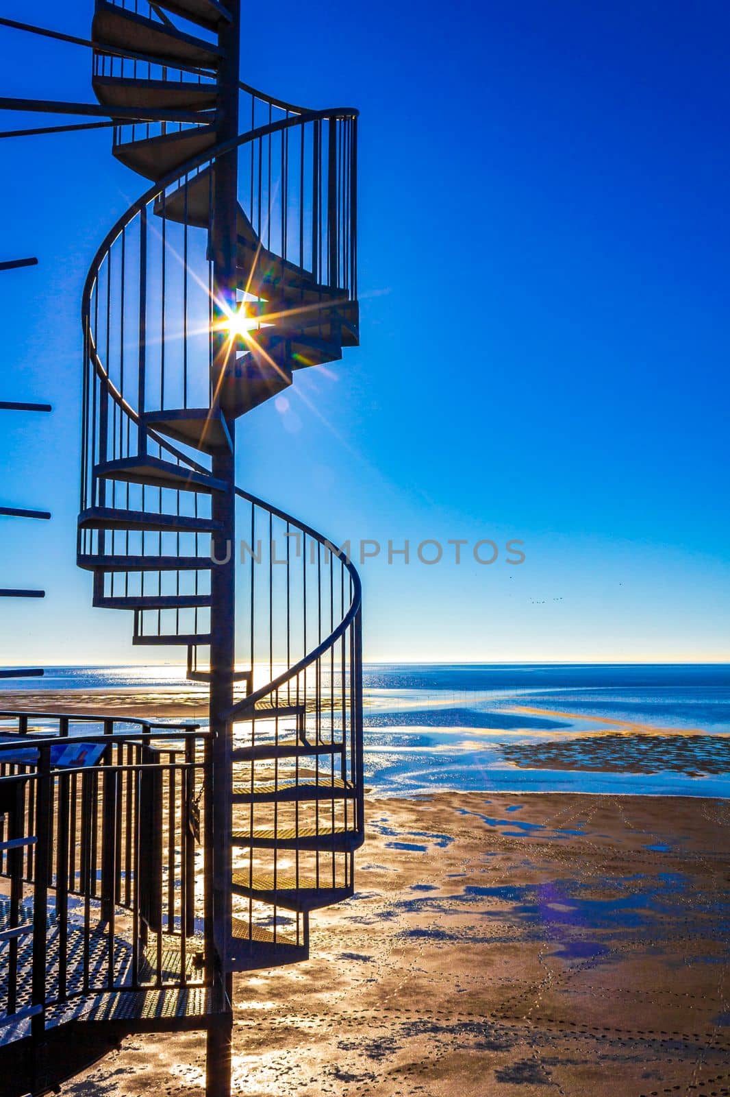 Black lighthouse tower Obererversand in Wadden Sea landscape in Dorum Wurster North Sea coast Wursten Cuxhaven Lower Saxony Germany.