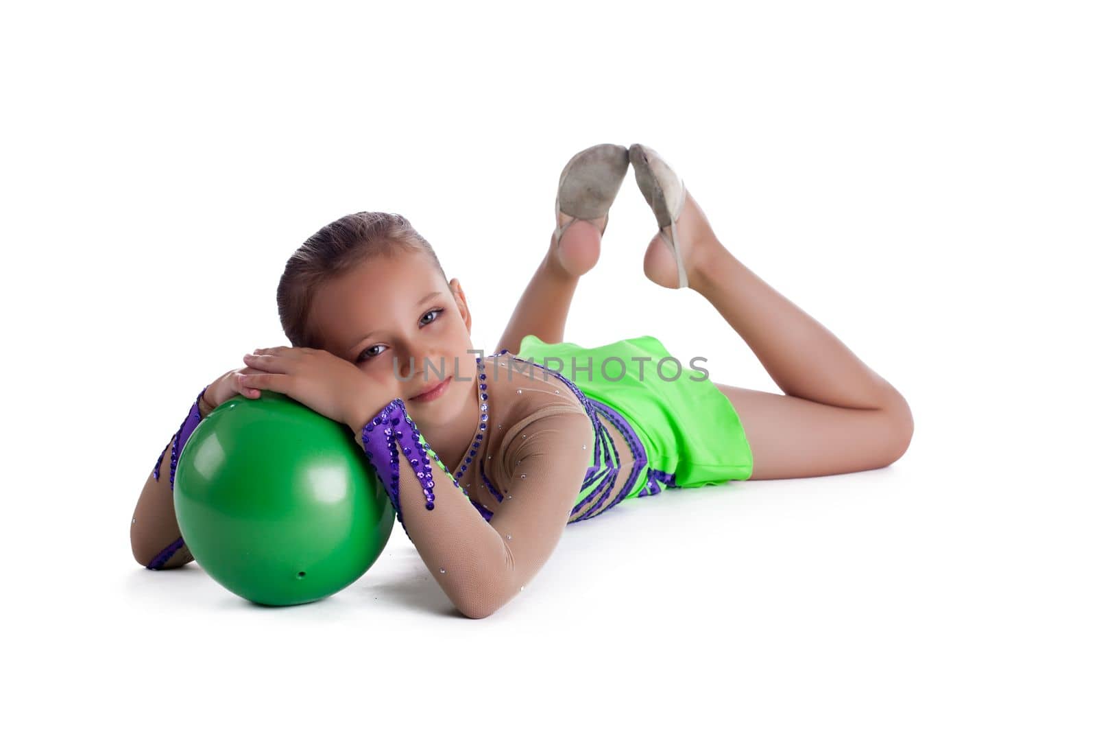 Kid lay with green gymnastic ball isolated