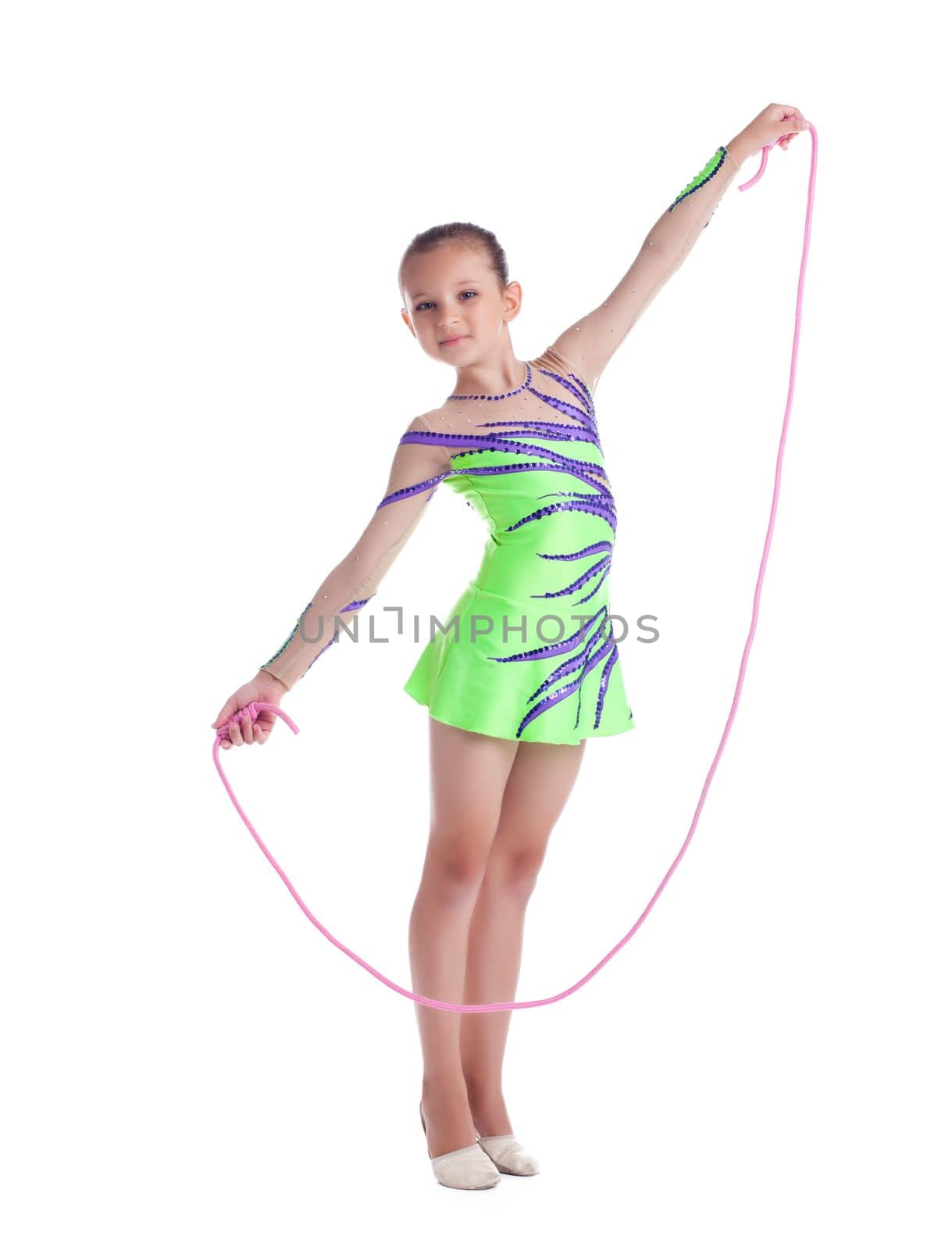 Young kid gymnast posing with skipping rope isolated
