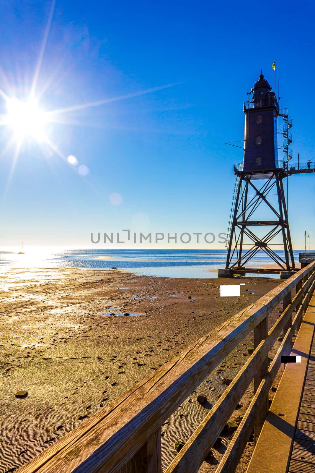 Black lighthouse tower Obererversand in Wadden Sea landscape in Dorum Wurster North Sea coast Wursten Cuxhaven Lower Saxony Germany.