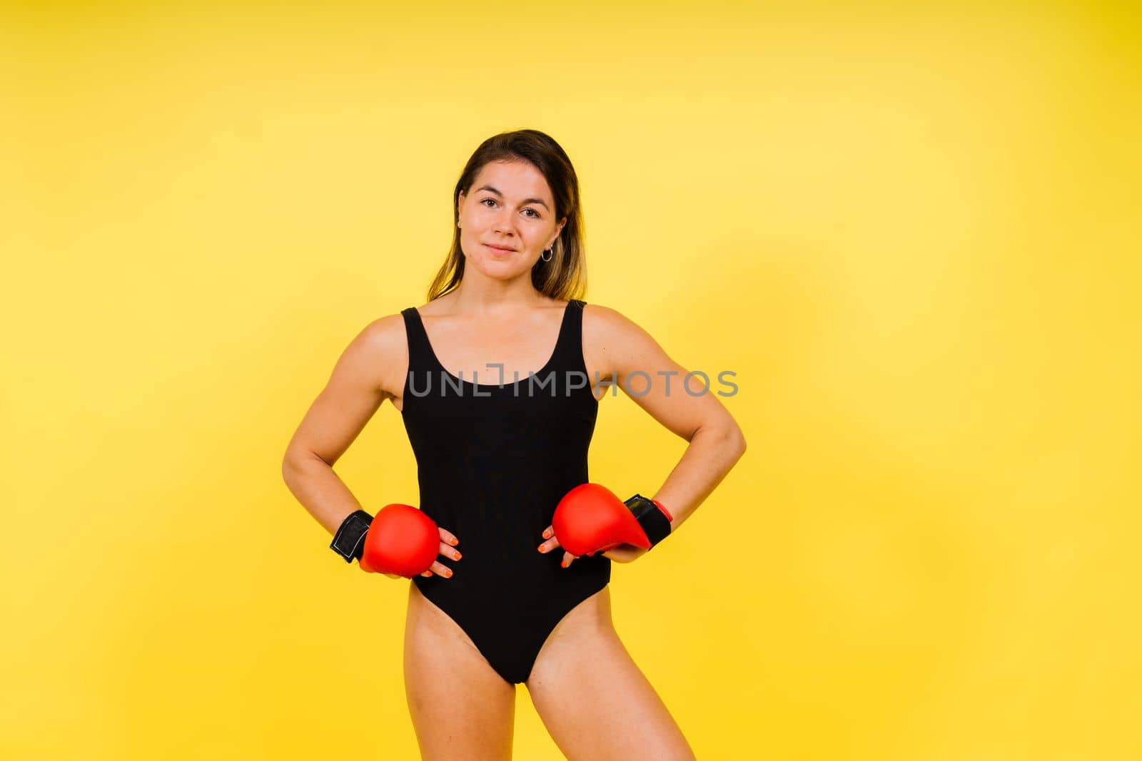 Woman Boxer In Gloves Training On black, red, yellow Background by Zelenin