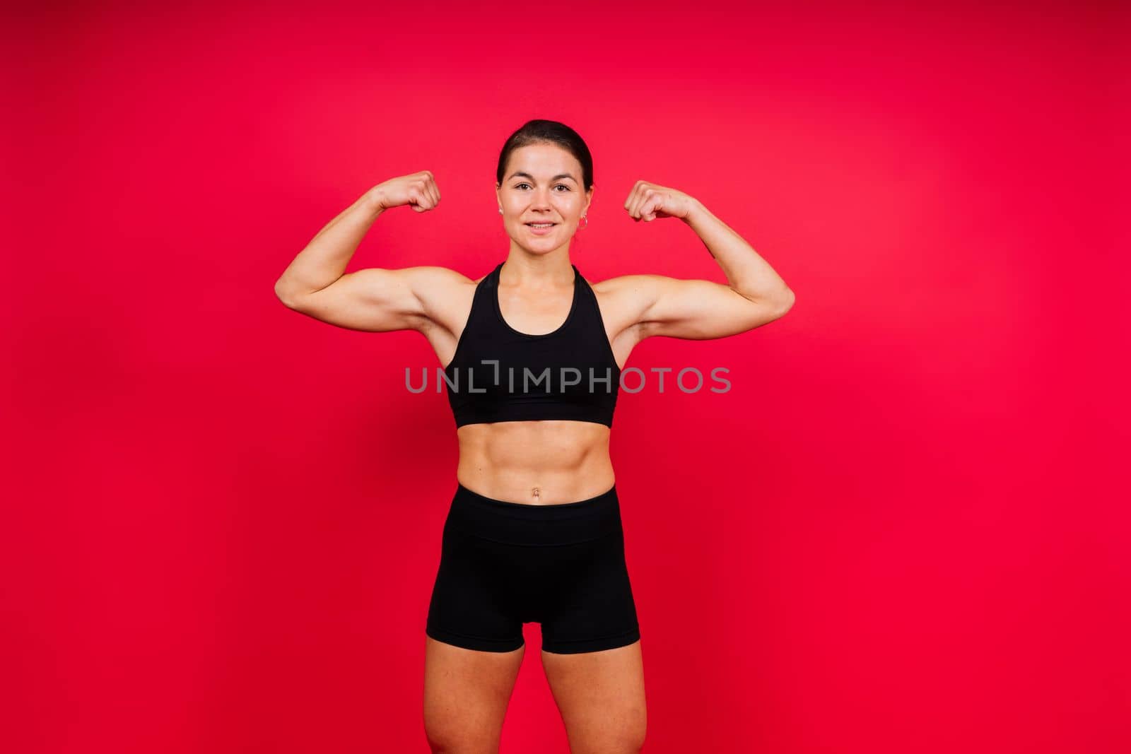 Woman Boxer In Gloves Training On a black, red, yellow Background