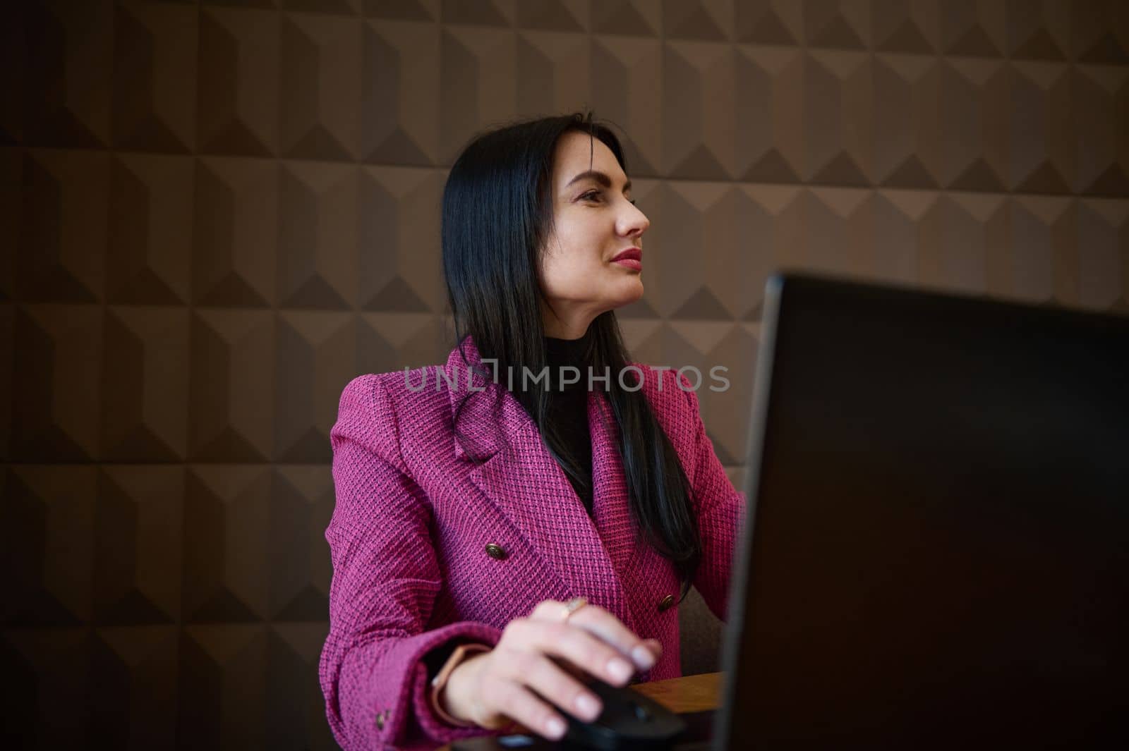 Confident, successful middle-aged woman, business lady, entrepreneur in casual clothes, working remotely on laptop at a cozy cafe interior. Online business, successful people, urban lifestyle concept