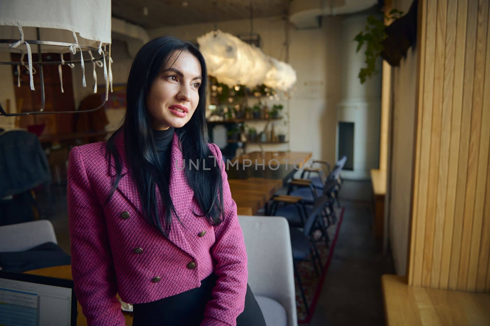 Portrait of confident Caucasian middle-aged businesswoman in elegant suit in modern restaurant interior. Business, finance and employment, female successful entrepreneurs concept. Restaurant business