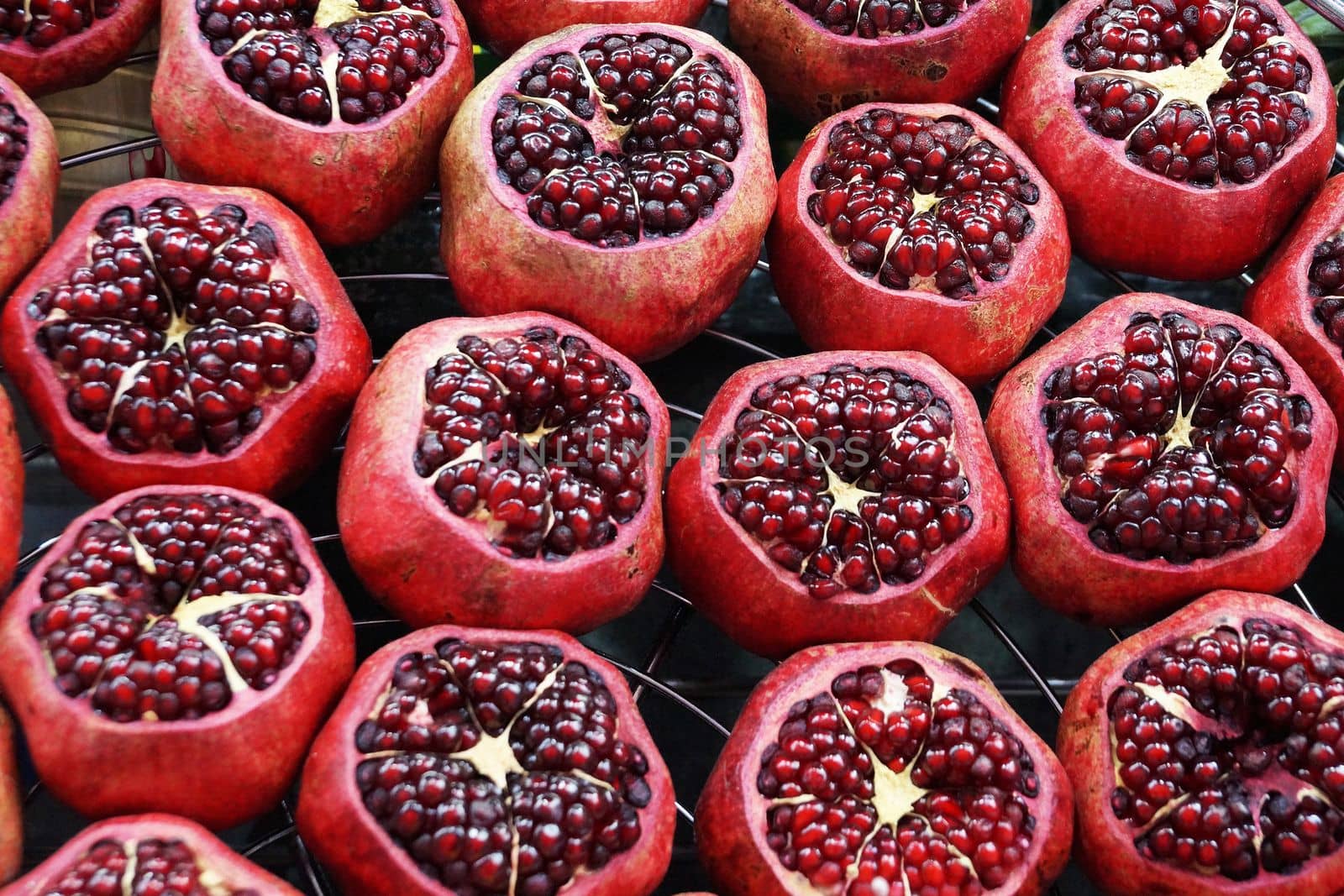 peeled fresh pomegranates for food background, top view.