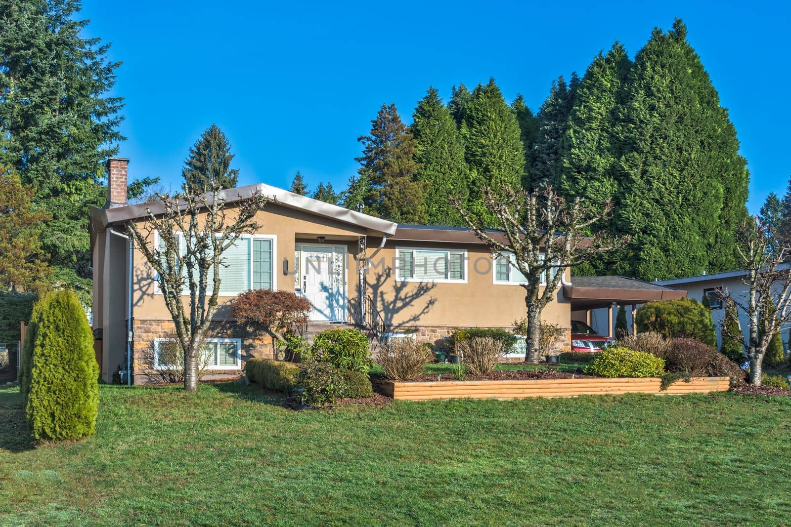 Front yard and main entrance door of residential house in British Columbia in December