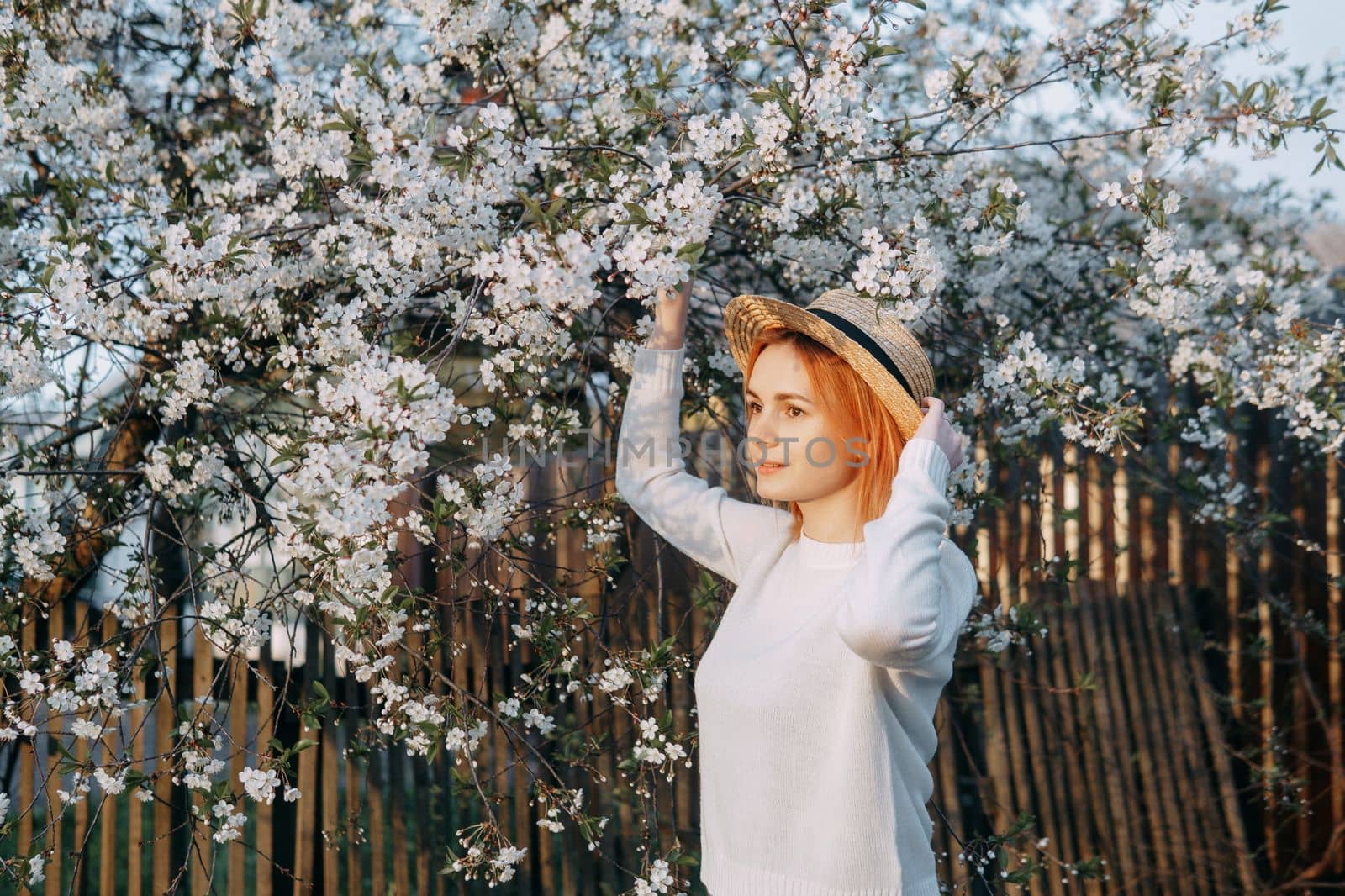 Portrait of a woman in a straw hat in a cherry blossom. Free outdoor recreation, spring blooming garden. by Annu1tochka