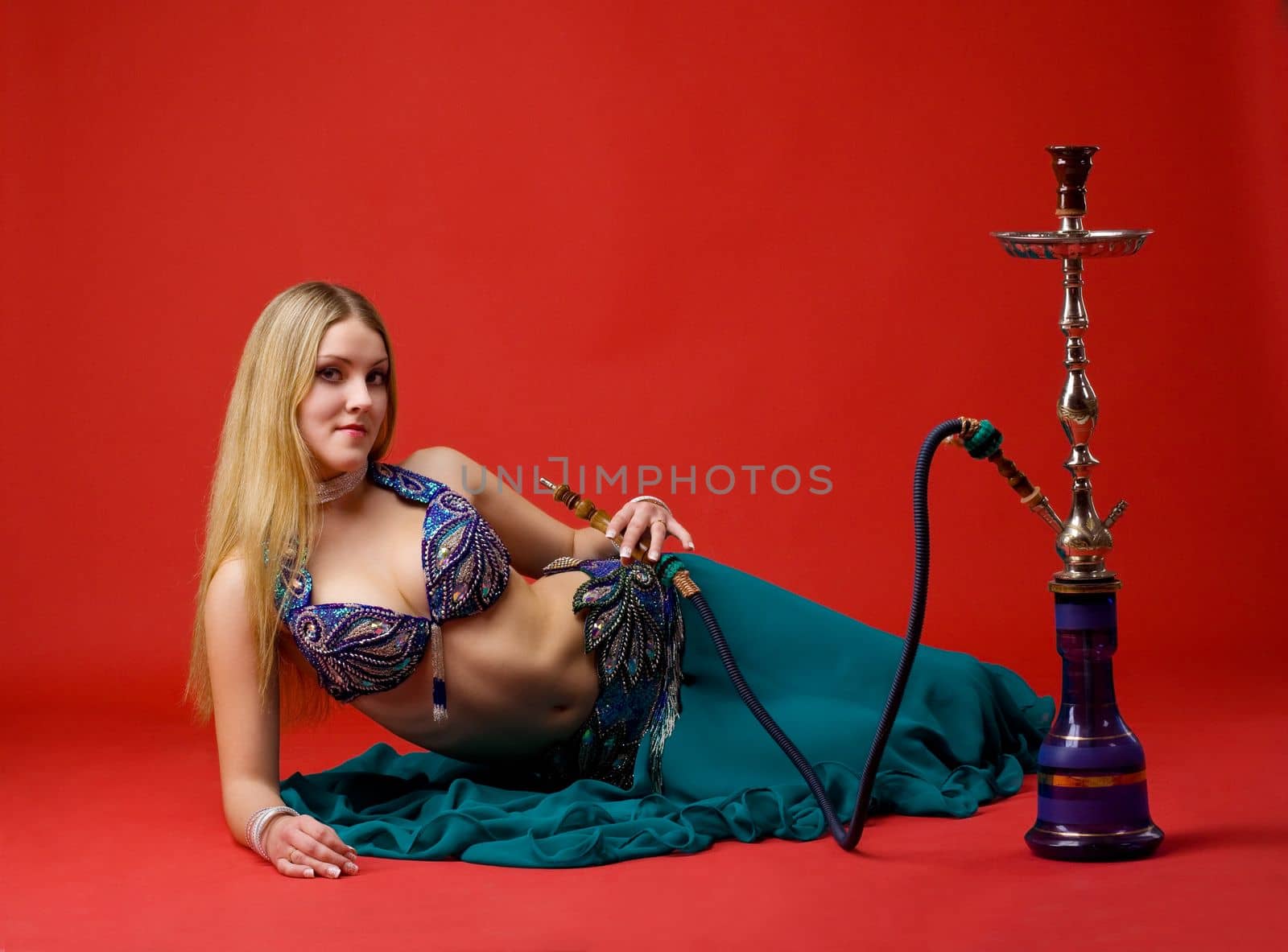 beauty young woman with hookah on red