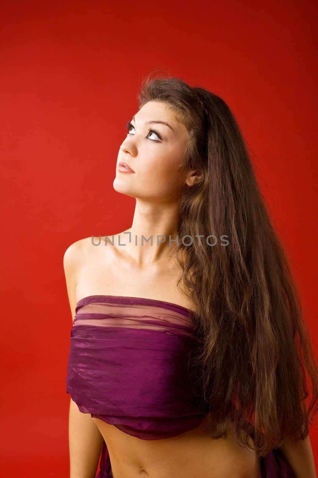 beauty woman in transparent veil on red background