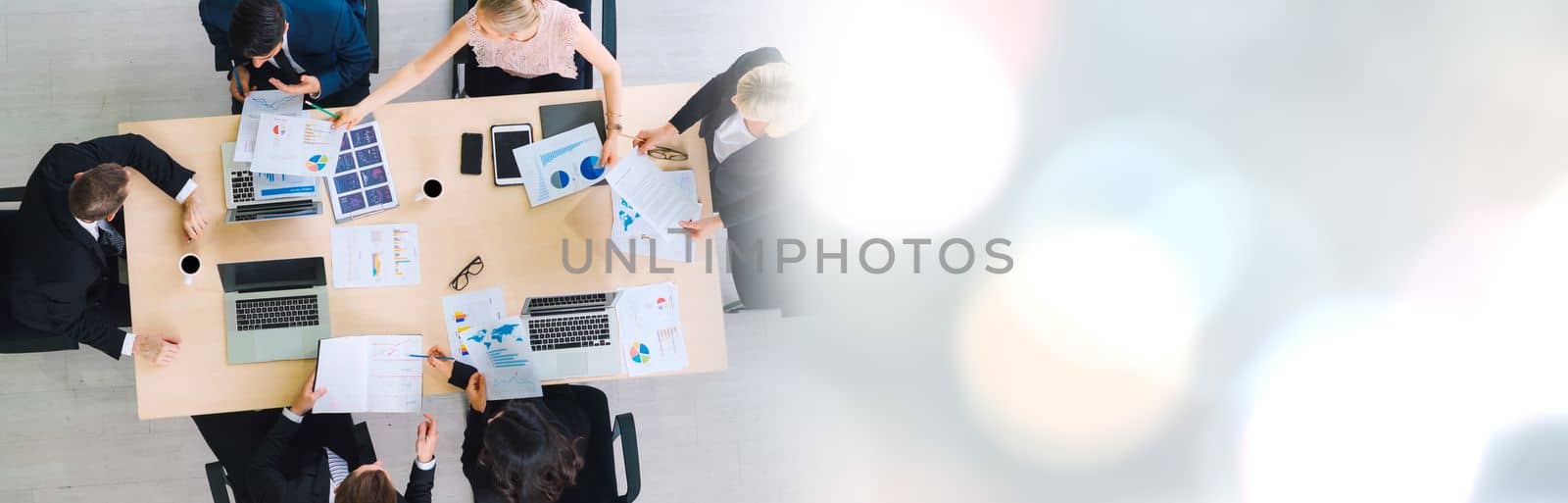 Business people group meeting shot from top widen view in office . Profession businesswomen, businessmen and office workers working in team conference with project planning document on meeting table .