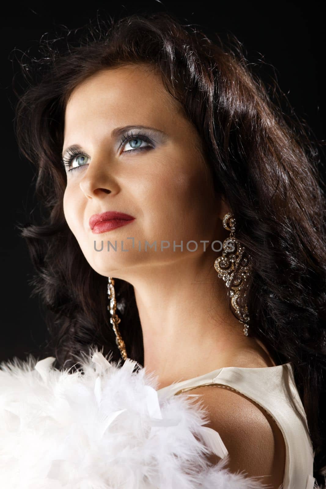 Beauty woman in white boa look at light