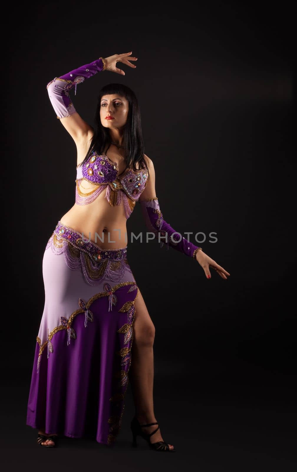 Woman dance in traditional purple arabian costume