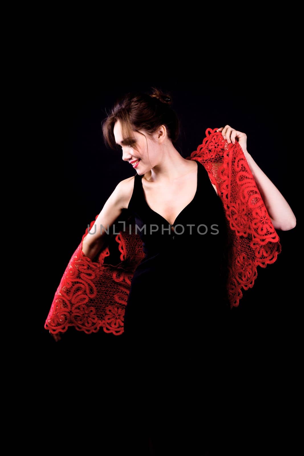 Woman in black dress with red lacy jacket