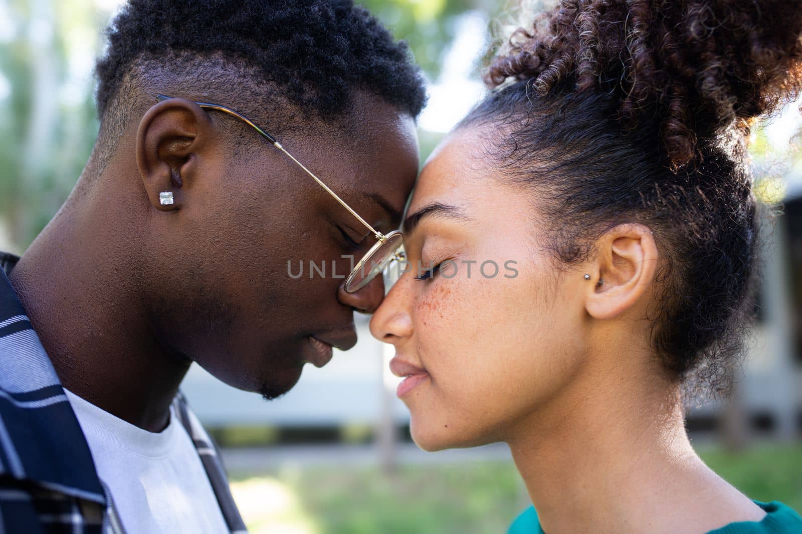 Young African American loving couple tenderly touching foreheads, sharing a romantic, intimate, affectionate moment. Relationship.