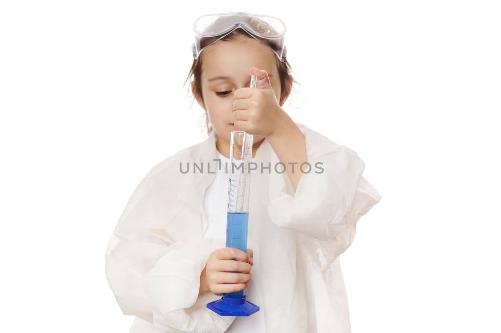 Details: hands of little child, chemist scientist dripping few drops of reagents into chemical solution in measuring cylinder, conducting chemical experiments, on white background. Chemistry Science
