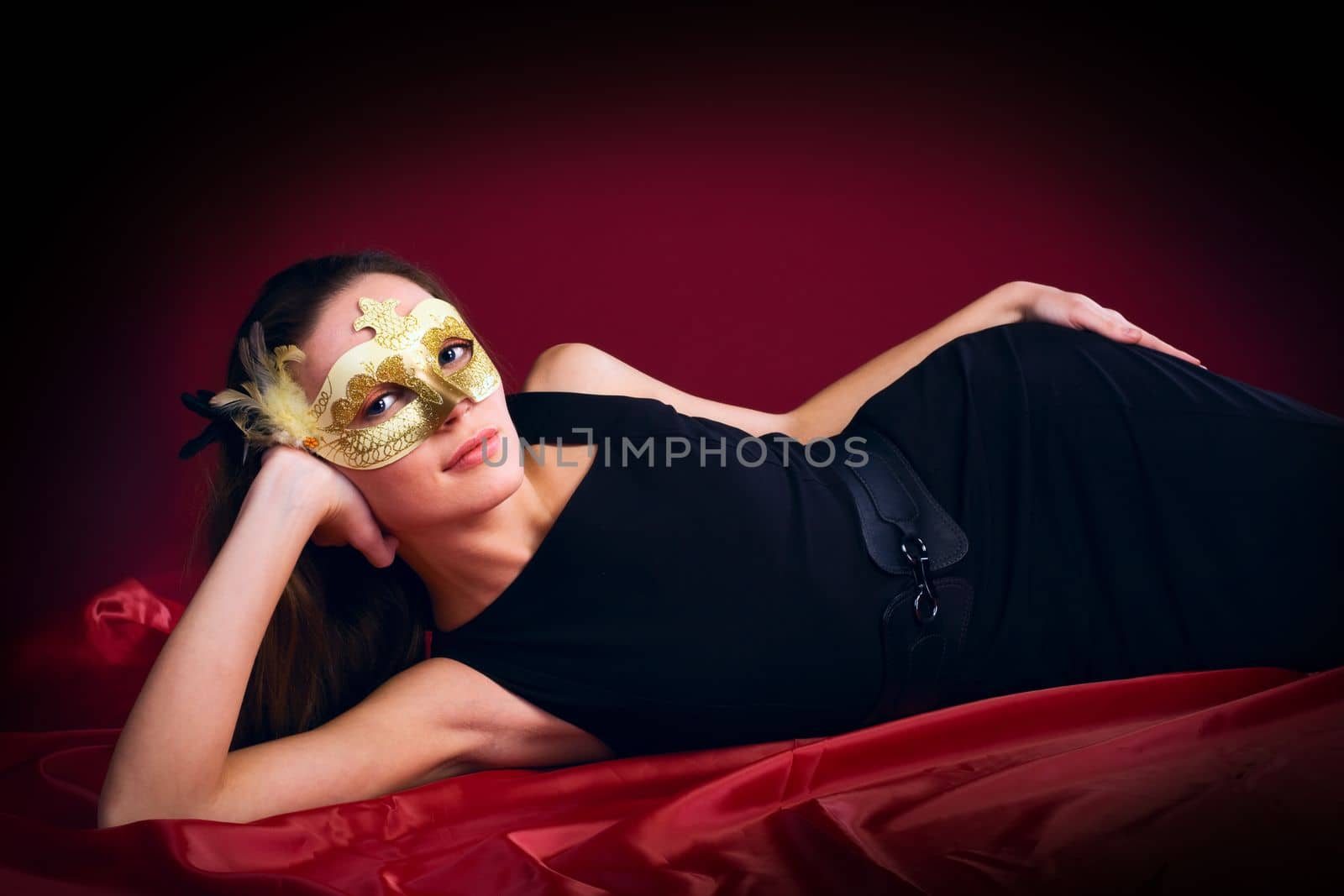 beauty woman in mask on red by rivertime