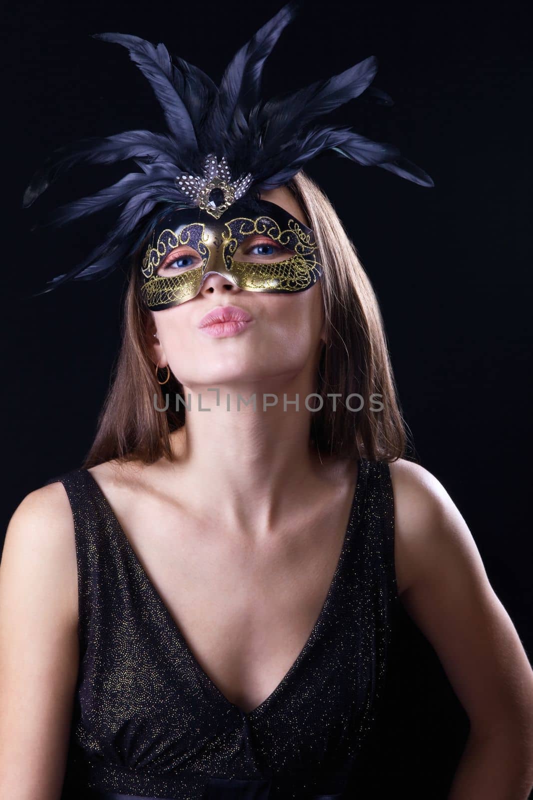 woman in mask with feather kiss you